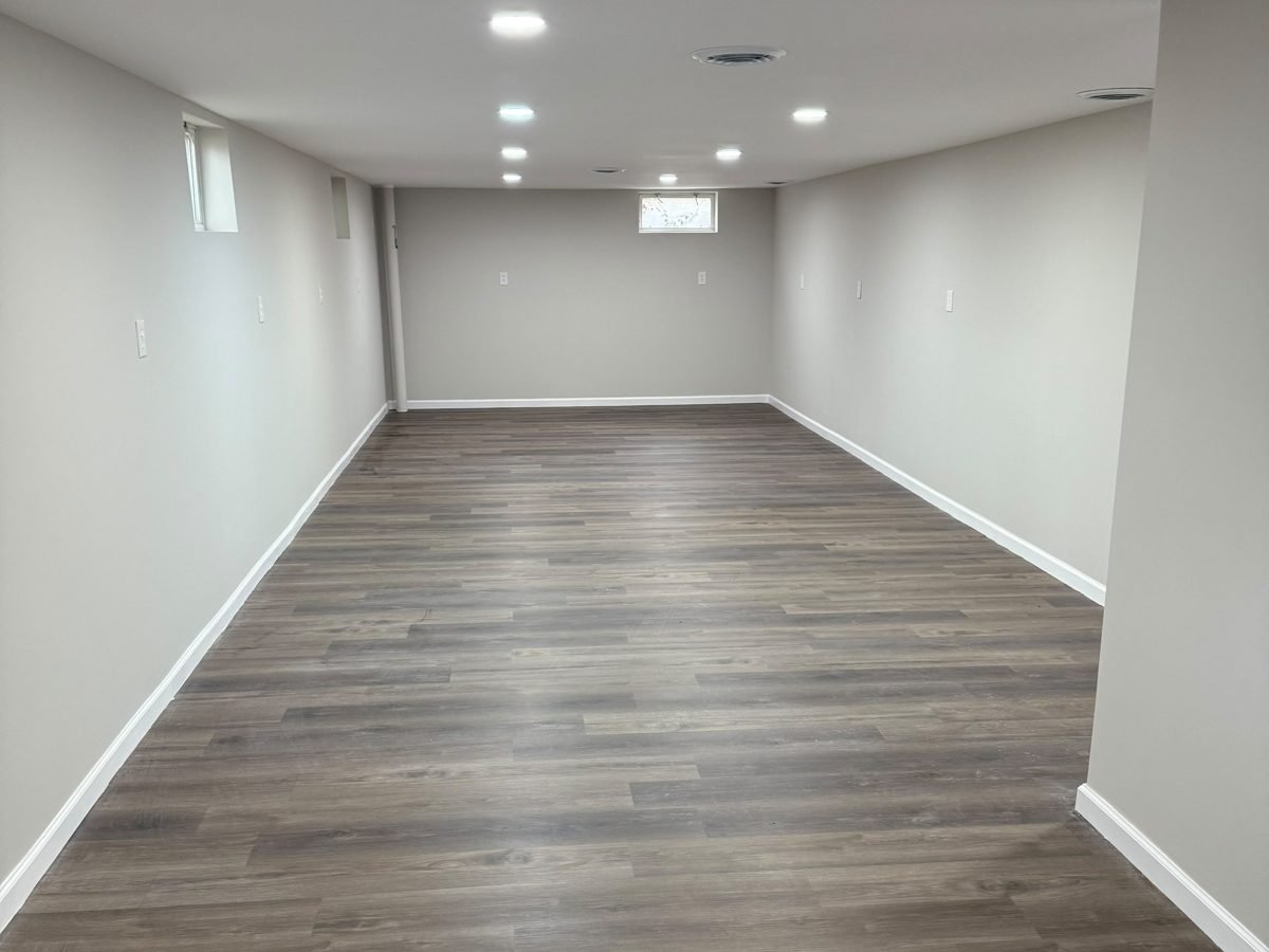 Finished basement with new drywall, recessed lighting and vinyl plank flooring